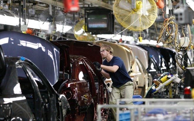 James burley works on the assembly line at the Toyota Motor Manufacturing, Kentucky plant in Georgetown, U.S. Courtesy-ED Reinke, Associated Press.