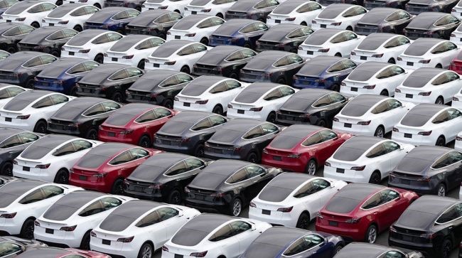 Electric Vehicles sales crossed 7% :Tesla vehicles in a parking lot after arriving at a port. (Toru Hanai/Bloomberg News)